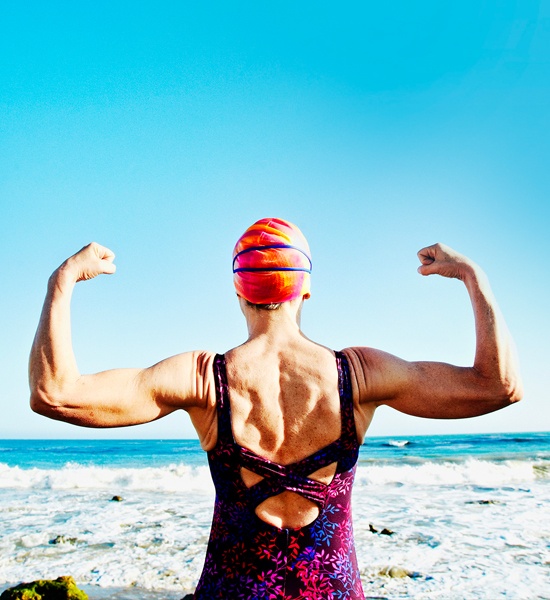 Strong and athletic female swimmer on the seashore