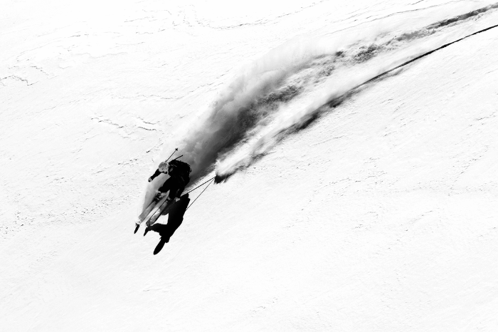 Woman skiing down a mountainside at great speed